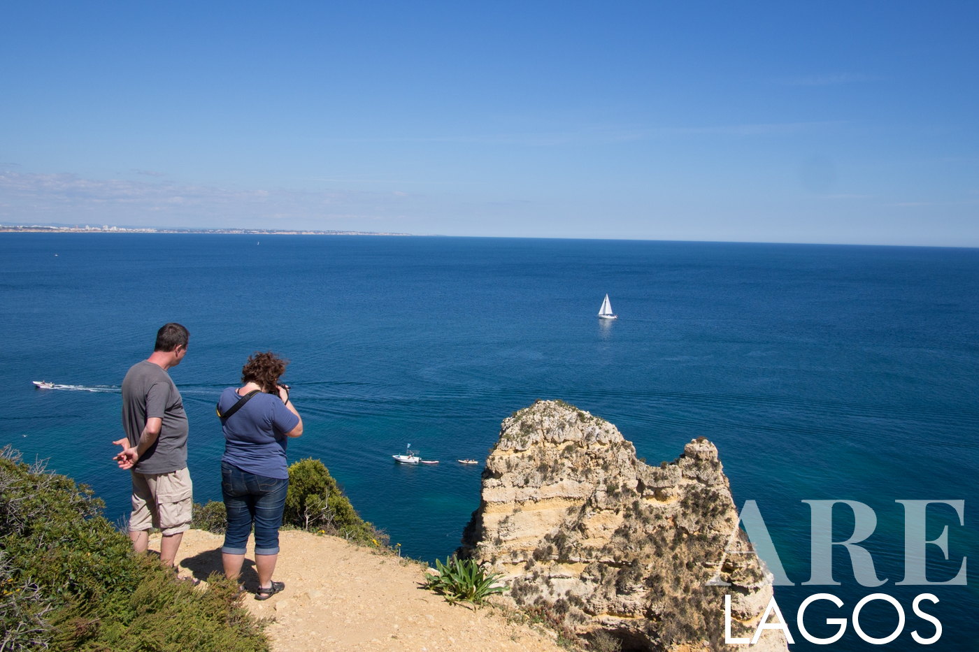 Tourists Capturing the Beauty of Lagos Coast Cliffs