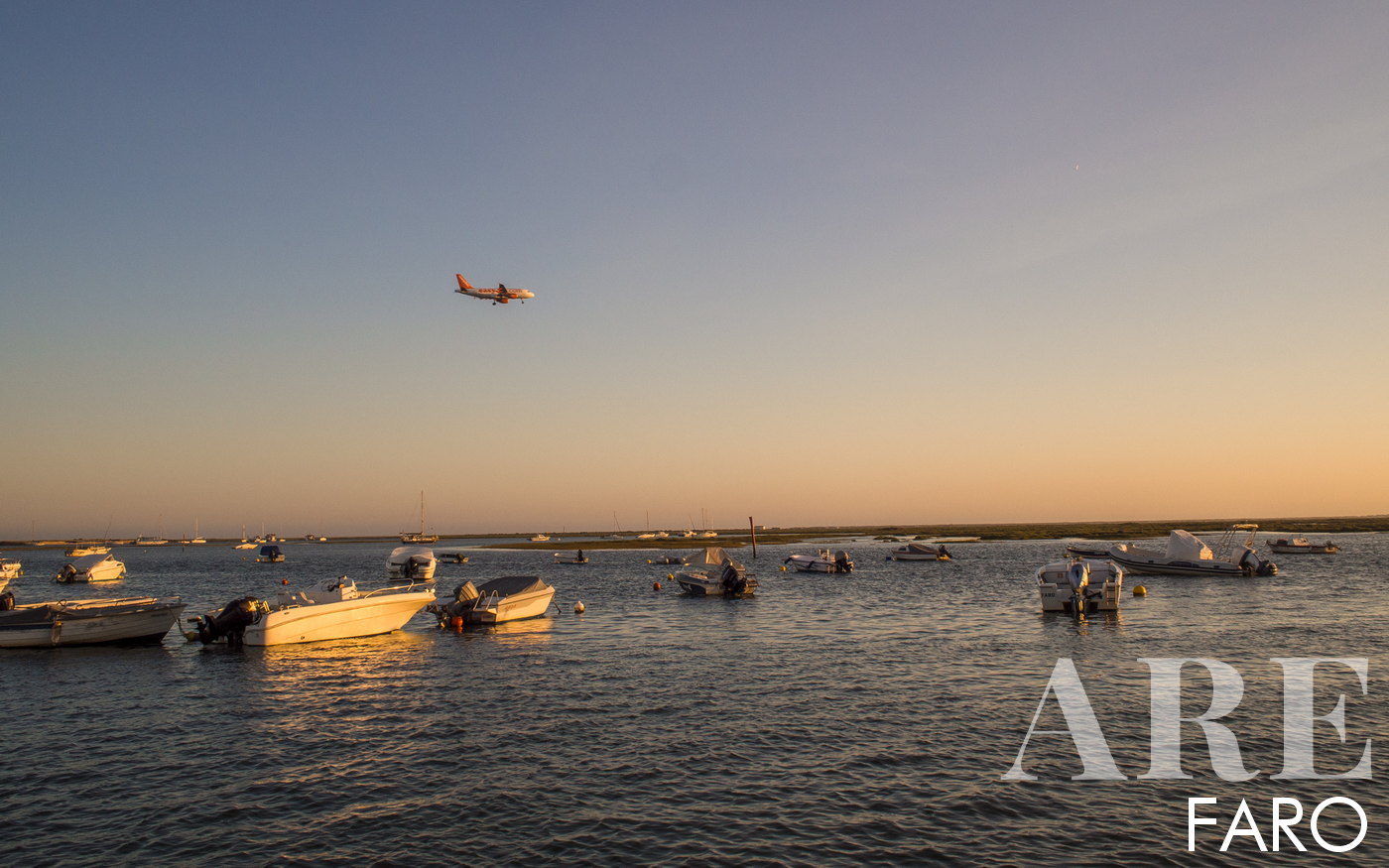 View of an airplane approaching Faro International Airport, showcasing the stunning natural beauty of Ria Formosa below