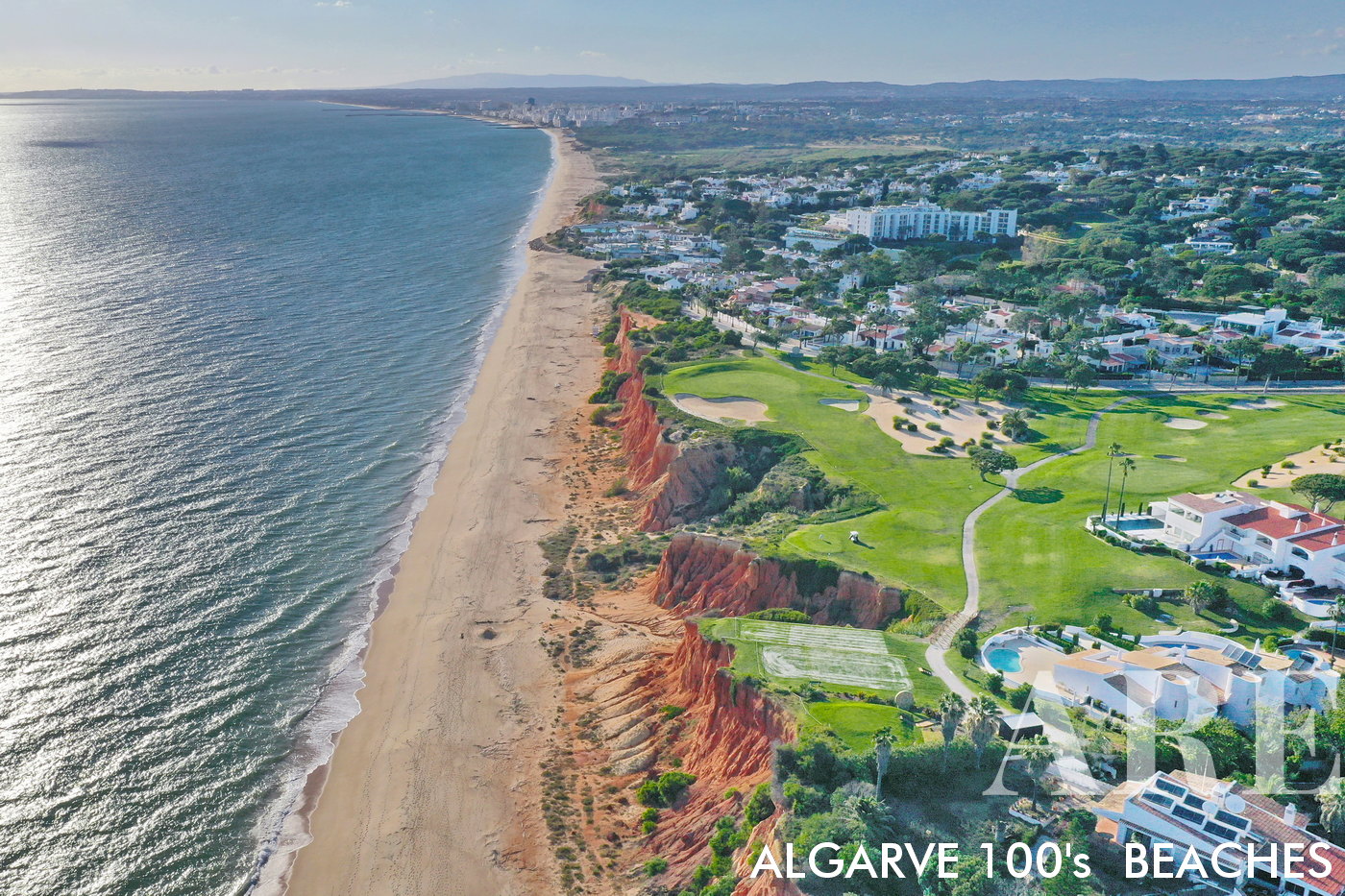 The view from Vale do Lobo beach towards the west encompasses the scenic stretch of coastline leading to the city of Quarteira and the Atlantic Ocean.