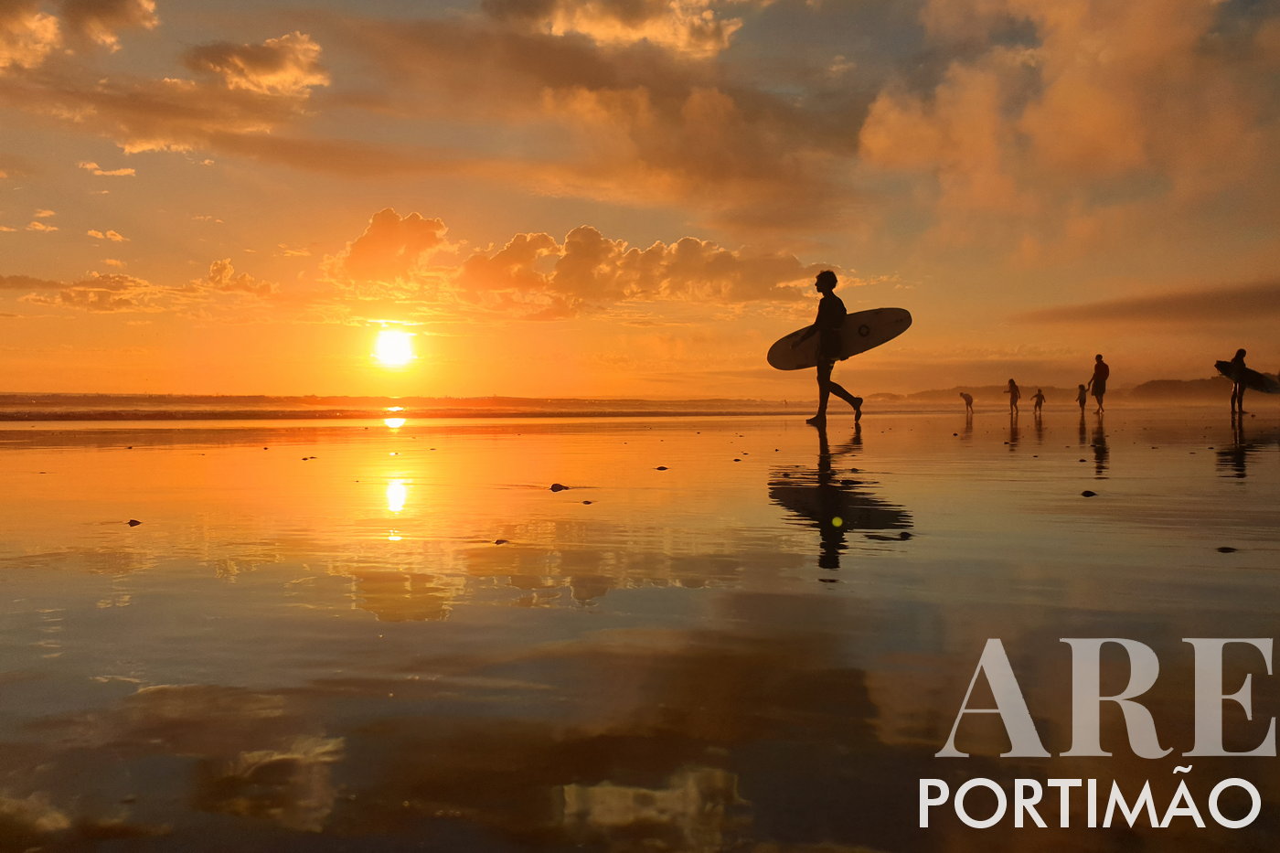 Surfers Embracing the Sunset Drama