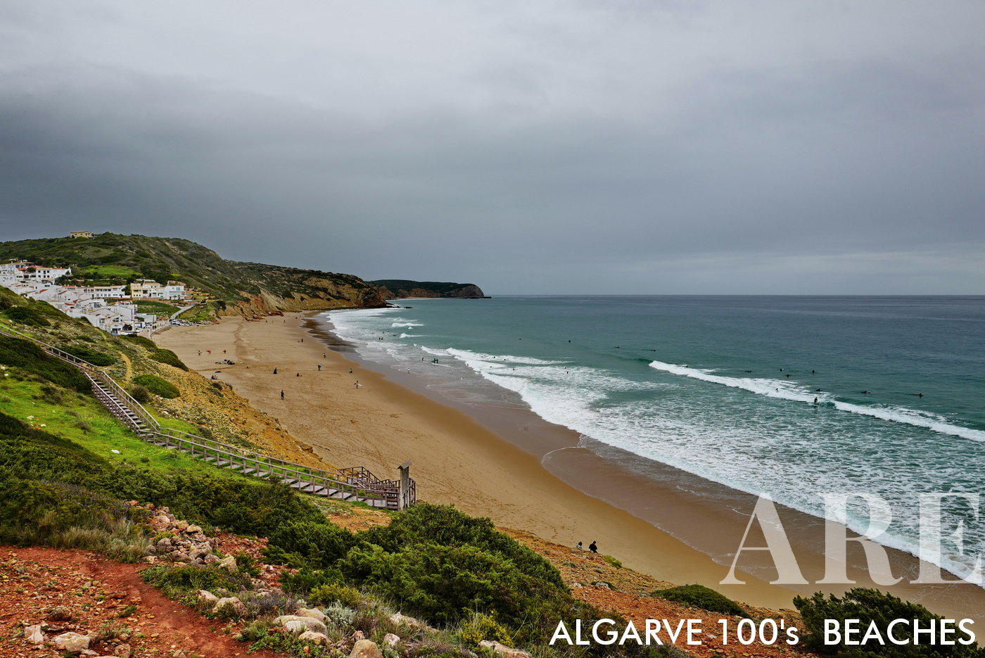 January brings surfers to Salema Beach, nestled in the bay in front of the quaint Salema village. The scene captures the charm of seaside living, perfectly paired with the thrill of riding winter waves.